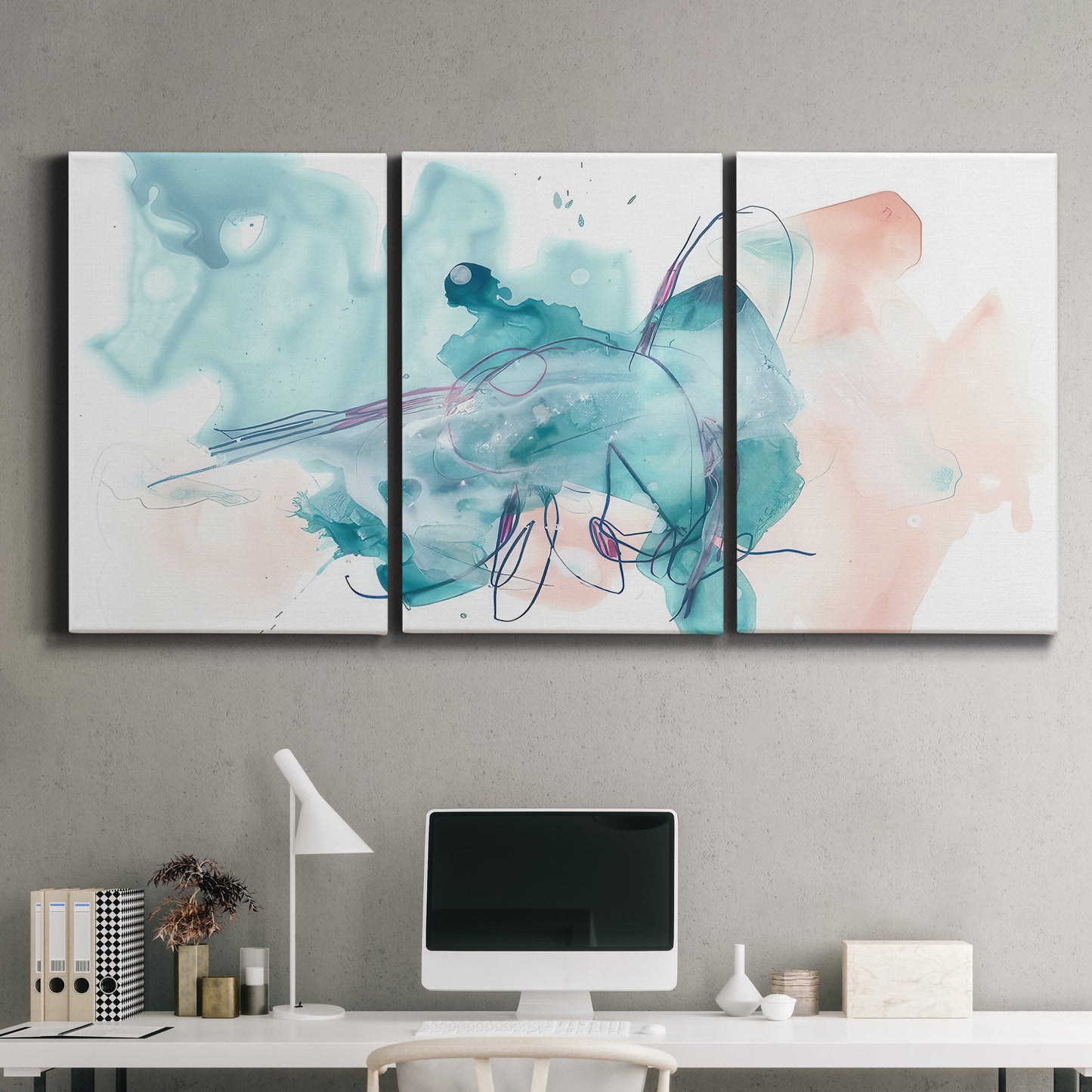 Three-panel canvas wall art featuring soft abstract watercolor forms, displayed above a desk in a home office.