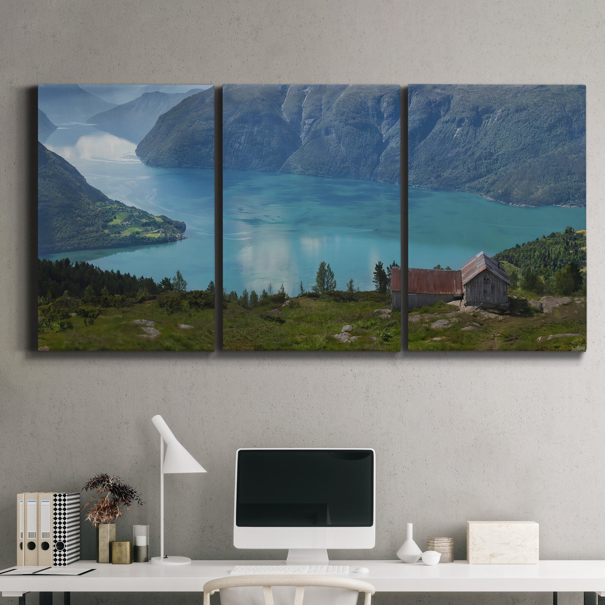 Three-panel canvas wall art featuring symmetrical water reflections with trees, displayed above a desk in a home office.