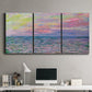 Three-panel canvas wall art featuring sunset reflections across calm sea, displayed above a desk in a home office.