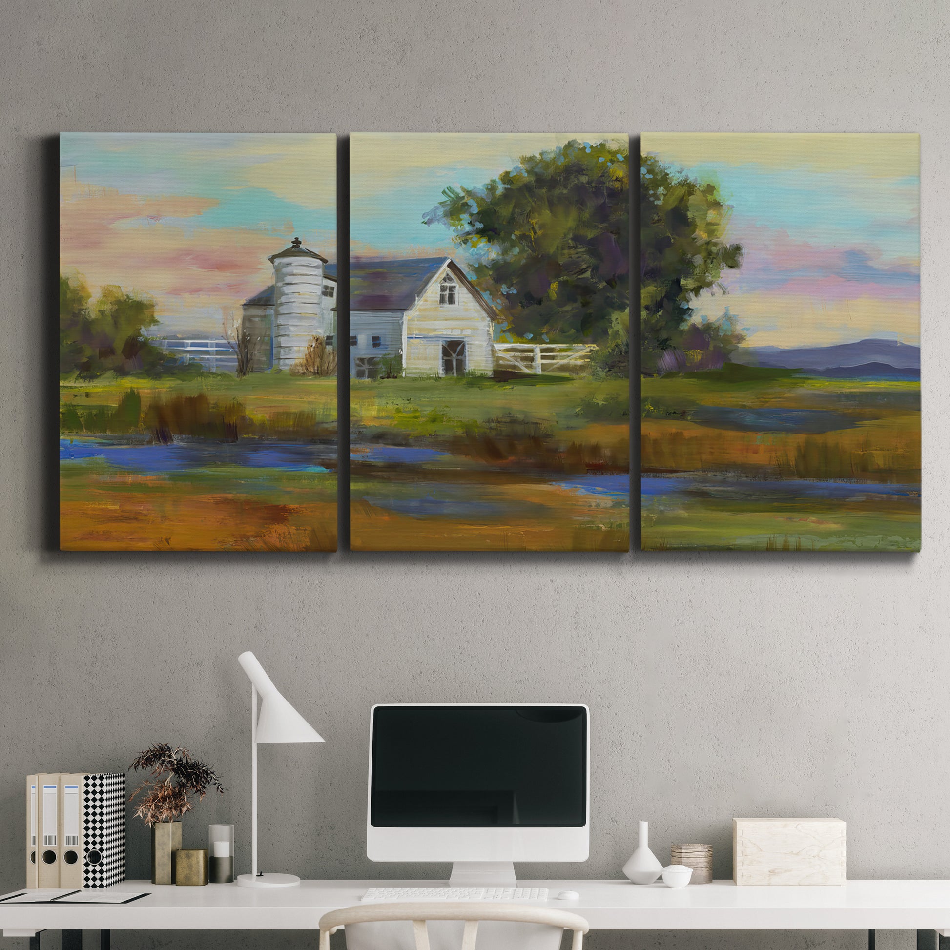 Three-panel canvas wall art featuring rural barn landscape with fields, displayed above a desk in a home office.