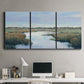 Three-panel canvas wall art featuring coastal plain with layered horizon, displayed above a desk in a home office.