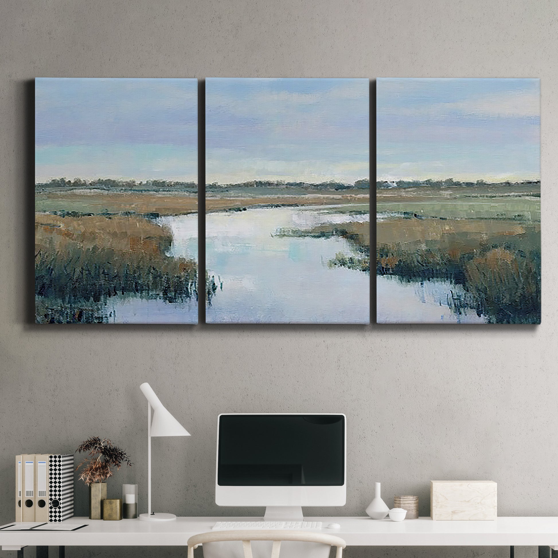 Three-panel canvas wall art featuring coastal plain with layered horizon, displayed above a desk in a home office.