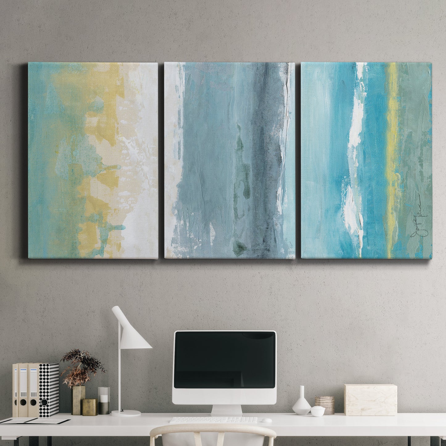 Three-panel canvas wall art featuring abstract coastal beach textures, displayed above a desk in a home office.