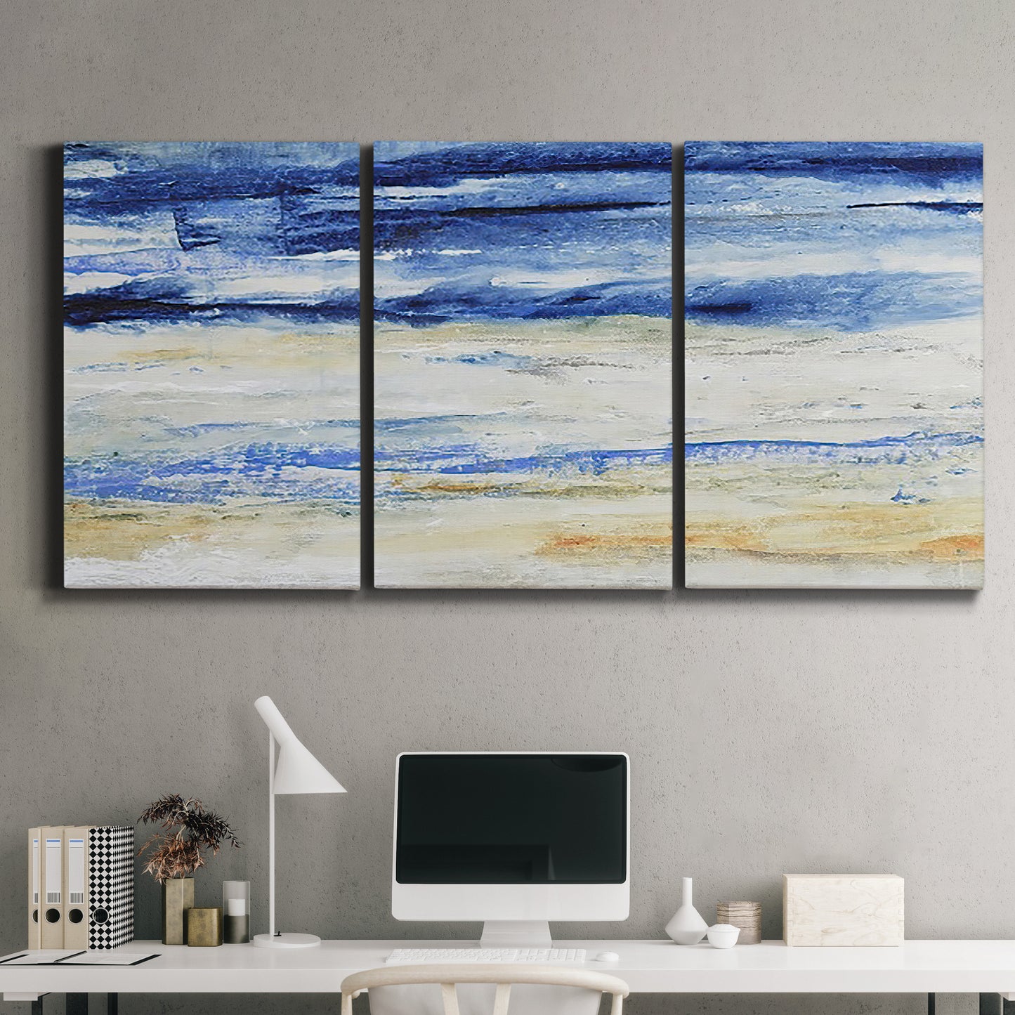 Three-panel canvas wall art featuring turbulent abstract ocean wave motion, displayed above a desk in a home office.