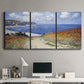 Three-panel canvas wall art featuring coastal path leading to sea, displayed above a desk in a home office.