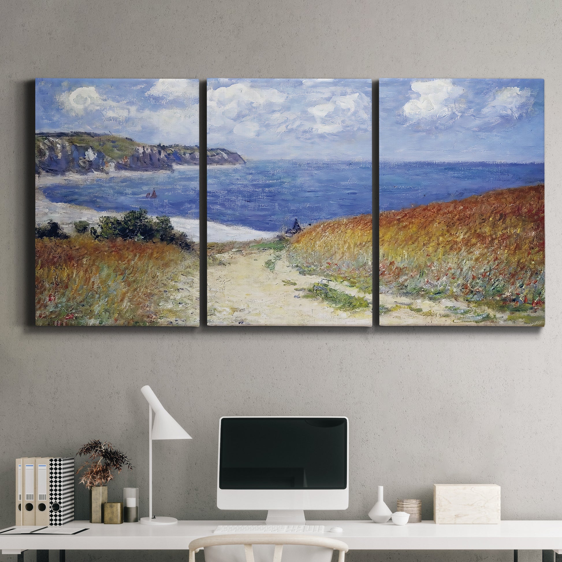 Three-panel canvas wall art featuring coastal path leading to sea, displayed above a desk in a home office.