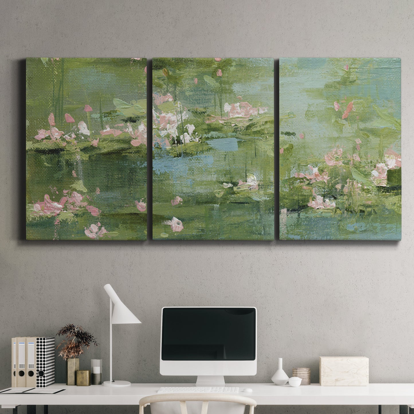 Three-panel canvas wall art featuring soft green water lilies, displayed above a desk in a home office.