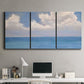 Three-panel canvas wall art featuring coastal shoreline with distant horizon, displayed above a desk in a home office.