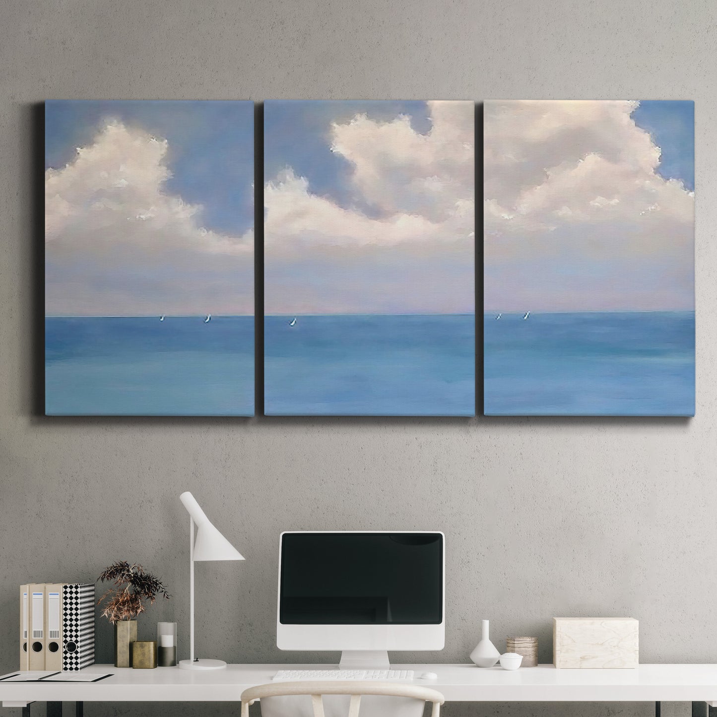 Three-panel canvas wall art featuring coastal shoreline with distant horizon, displayed above a desk in a home office.