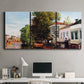 Three-panel canvas wall art featuring riverside houses along canal, displayed above a desk in a home office.