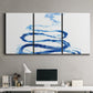 Three-panel canvas wall art featuring indigo abstract vapor watercolor, displayed above a desk in a home office.