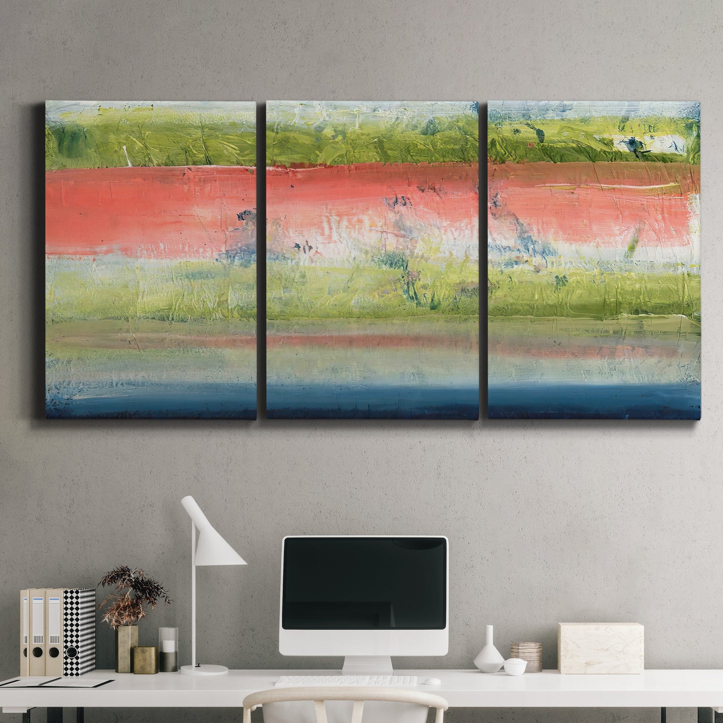 Three-panel canvas wall art featuring layered abstract color banding, displayed above a desk in a home office.