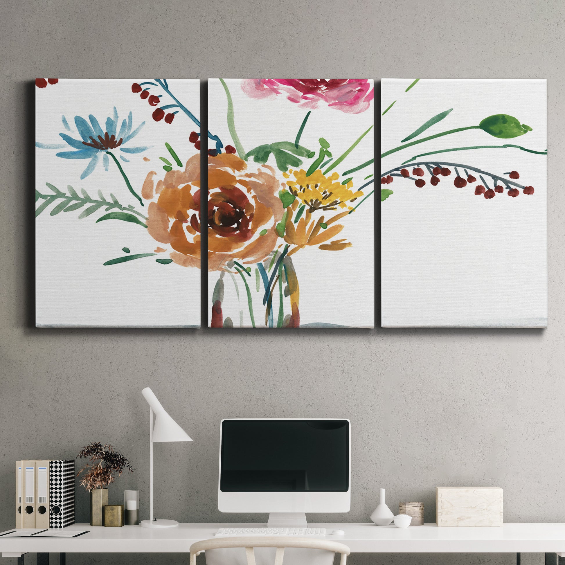 Three-panel canvas wall art featuring vibrant floral bouquet, displayed above a desk in a home office.