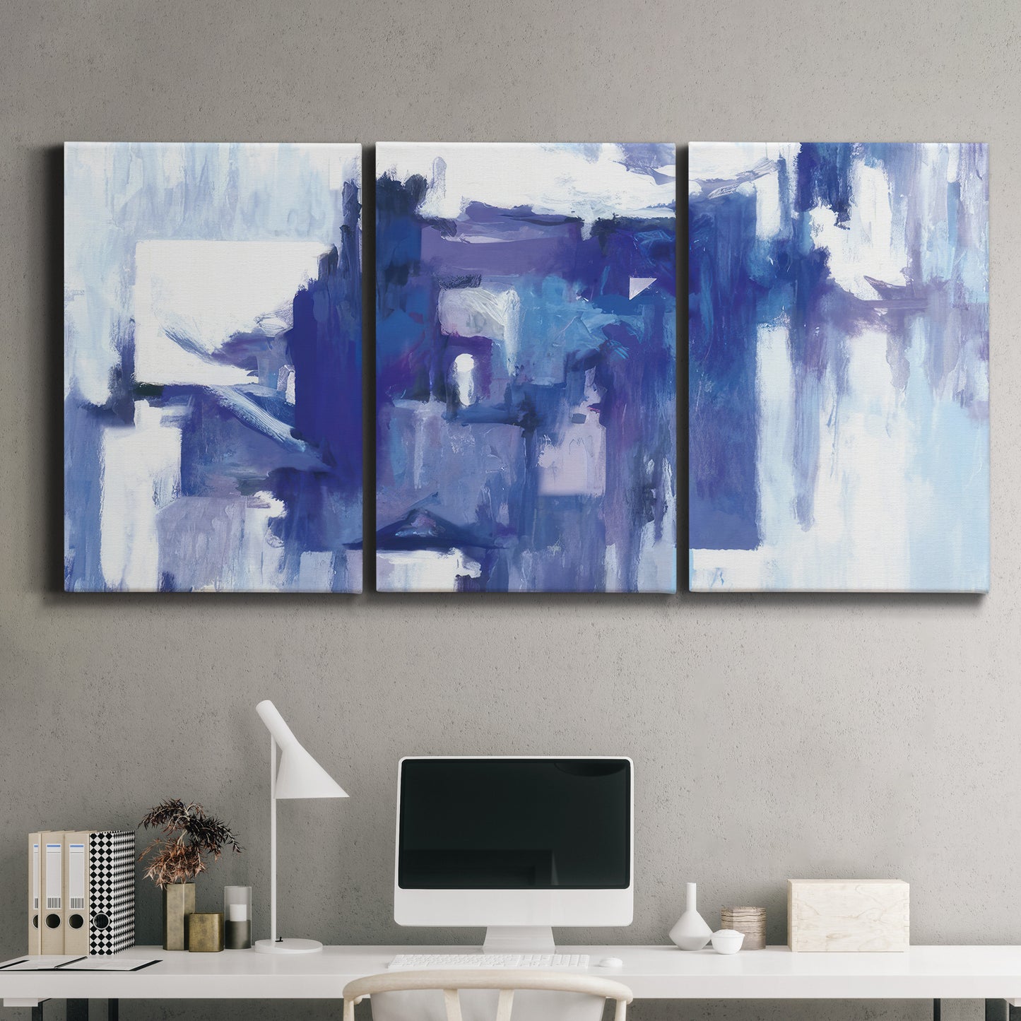 Three-panel canvas wall art featuring abstract urban street scene, displayed above a desk in a home office.
