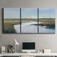 Three-panel canvas wall art featuring coastal plain meeting open water, displayed above a desk in a home office.
