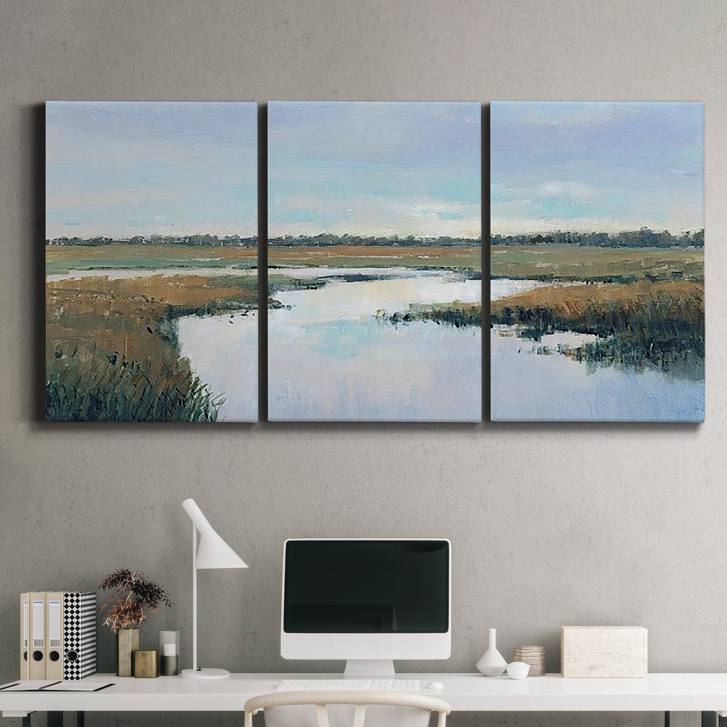 Three-panel canvas wall art featuring coastal plain meeting open water, displayed above a desk in a home office.