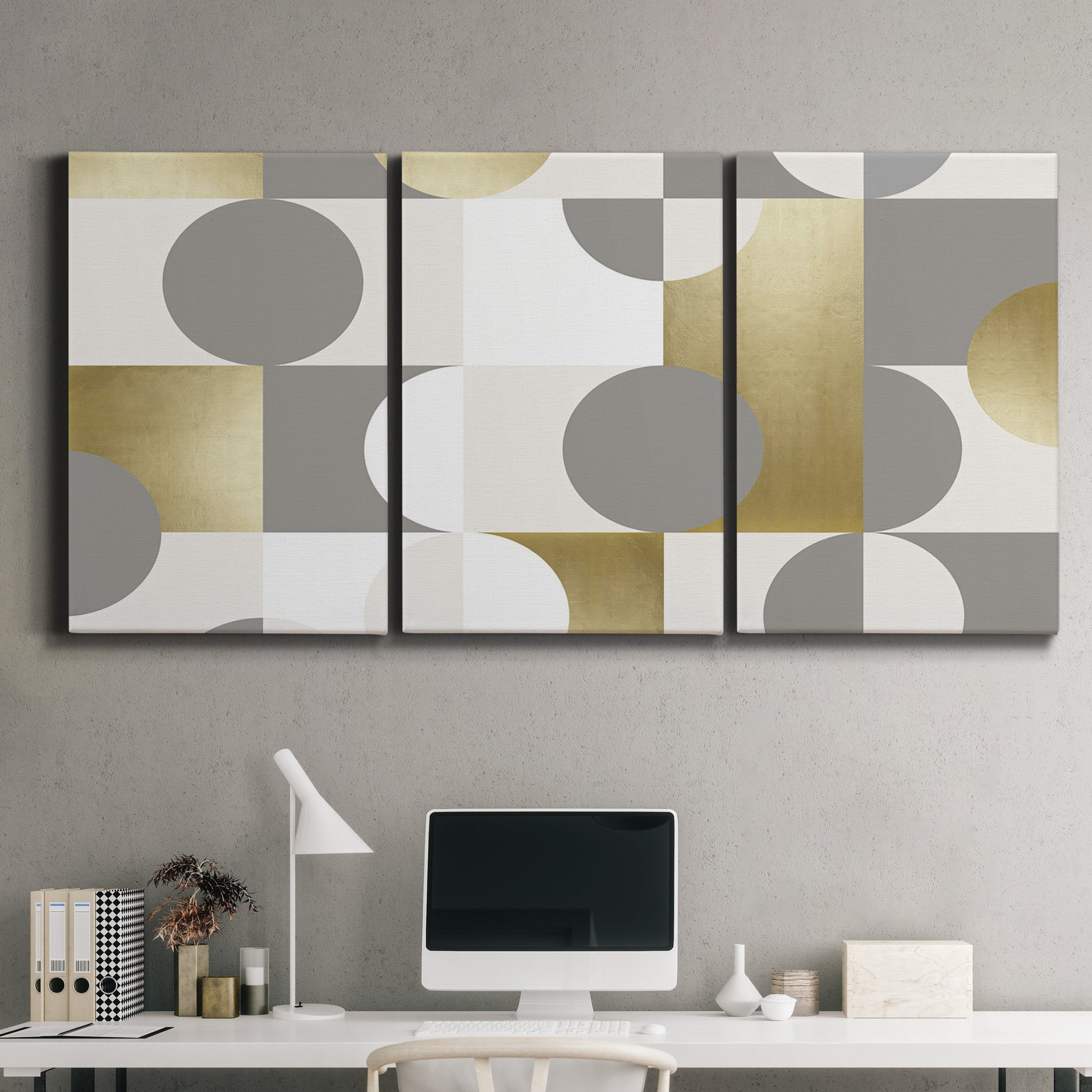 Three-panel canvas wall art featuring geometric gold abstract reflections, displayed above a desk in a home office.