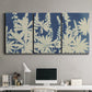Three-panel canvas wall art featuring delicate lupine floral composition, displayed above a desk in a home office.