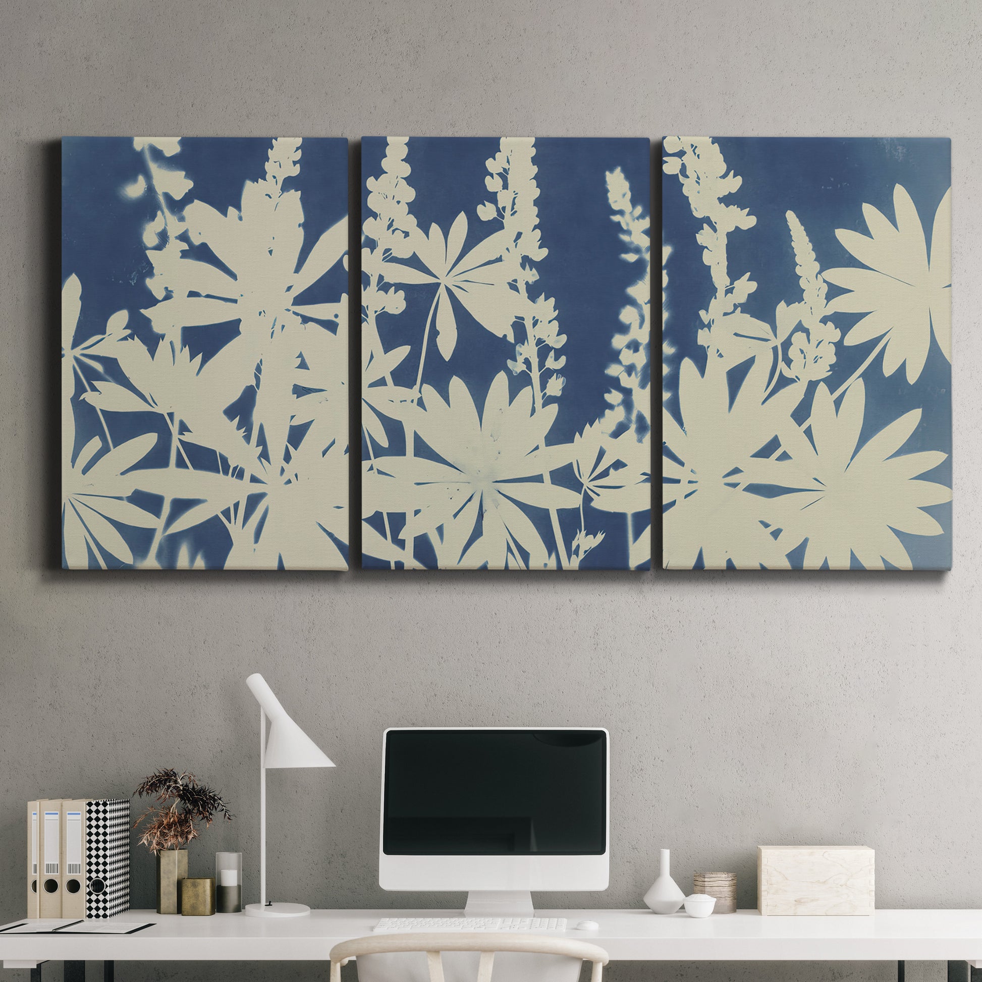 Three-panel canvas wall art featuring delicate lupine floral composition, displayed above a desk in a home office.