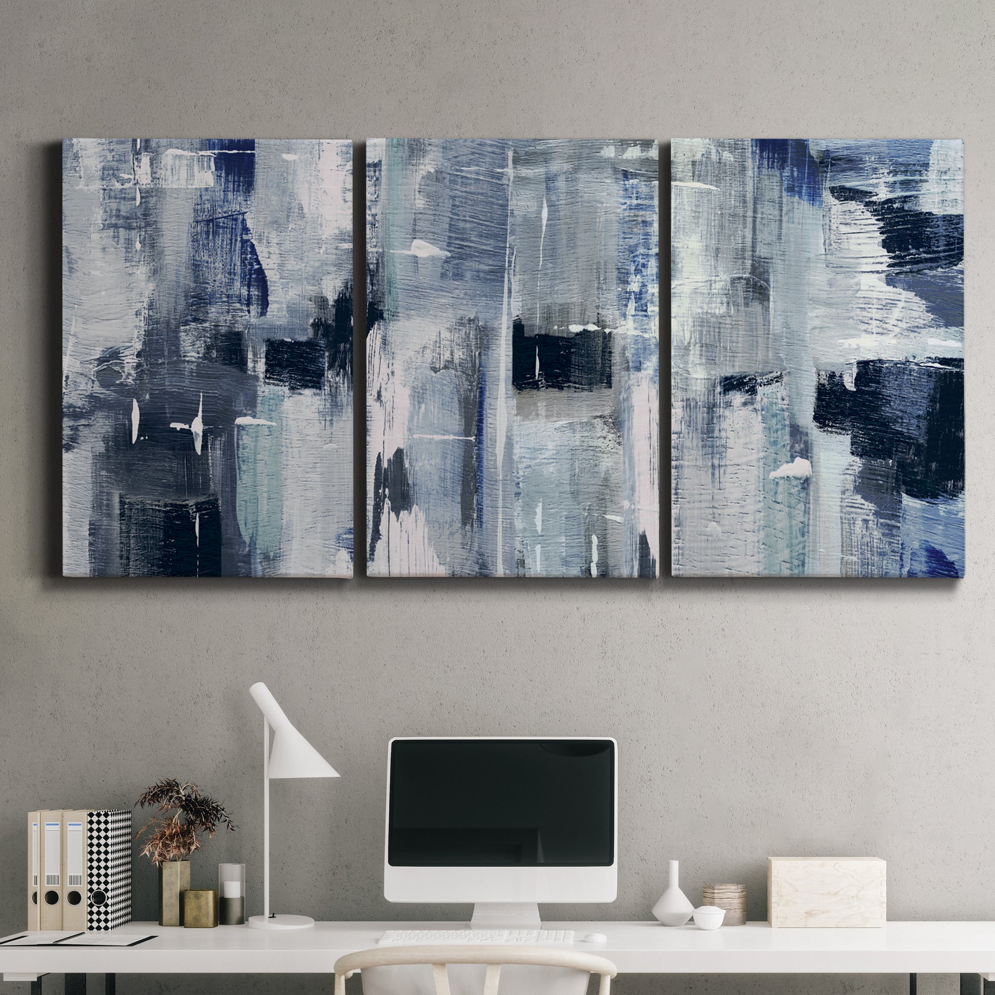 Three-panel canvas wall art featuring soft abstract mountain color fields, displayed above a desk in a home office.