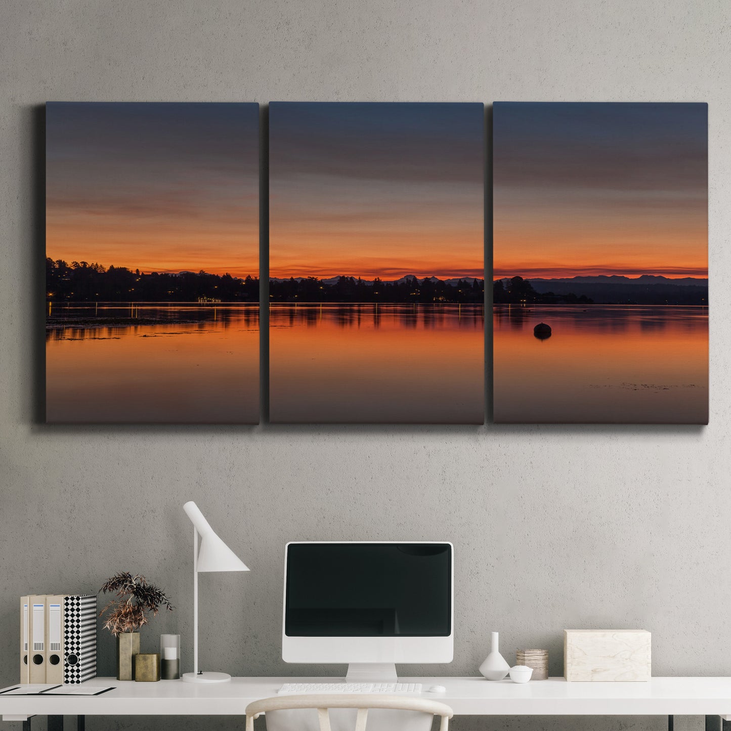 Three-panel canvas wall art featuring glowing sunset over water, displayed above a desk in a home office.