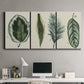 Three-panel canvas wall art featuring botanical palm leaf illustration, displayed above a desk in a home office.
