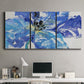 Three-panel canvas wall art featuring blue floral botanical close up, displayed above a desk in a home office.