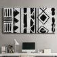 Three-panel canvas wall art featuring geometric abstract forms merging pattern, displayed above a desk in a home office.
