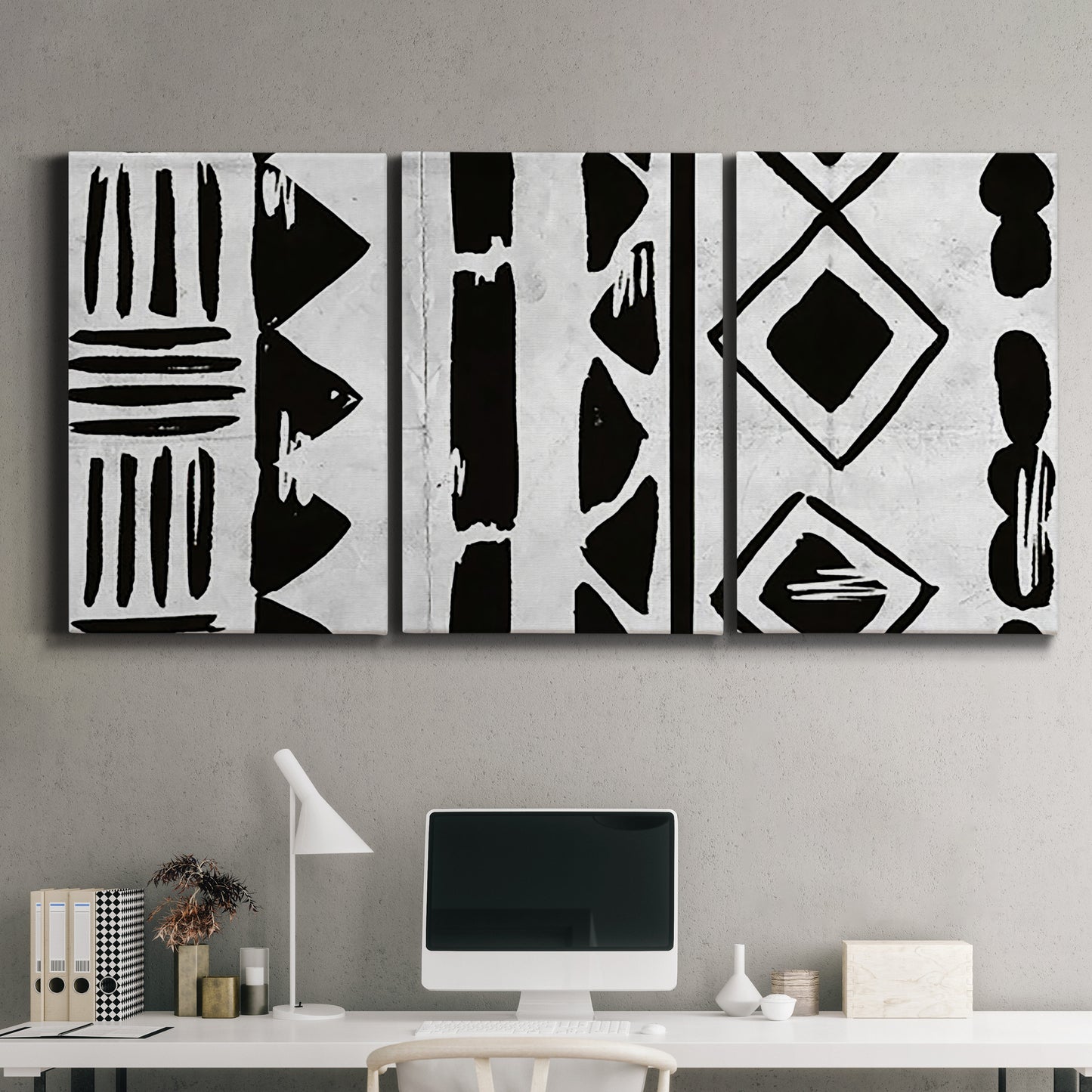 Three-panel canvas wall art featuring geometric abstract forms merging pattern, displayed above a desk in a home office.