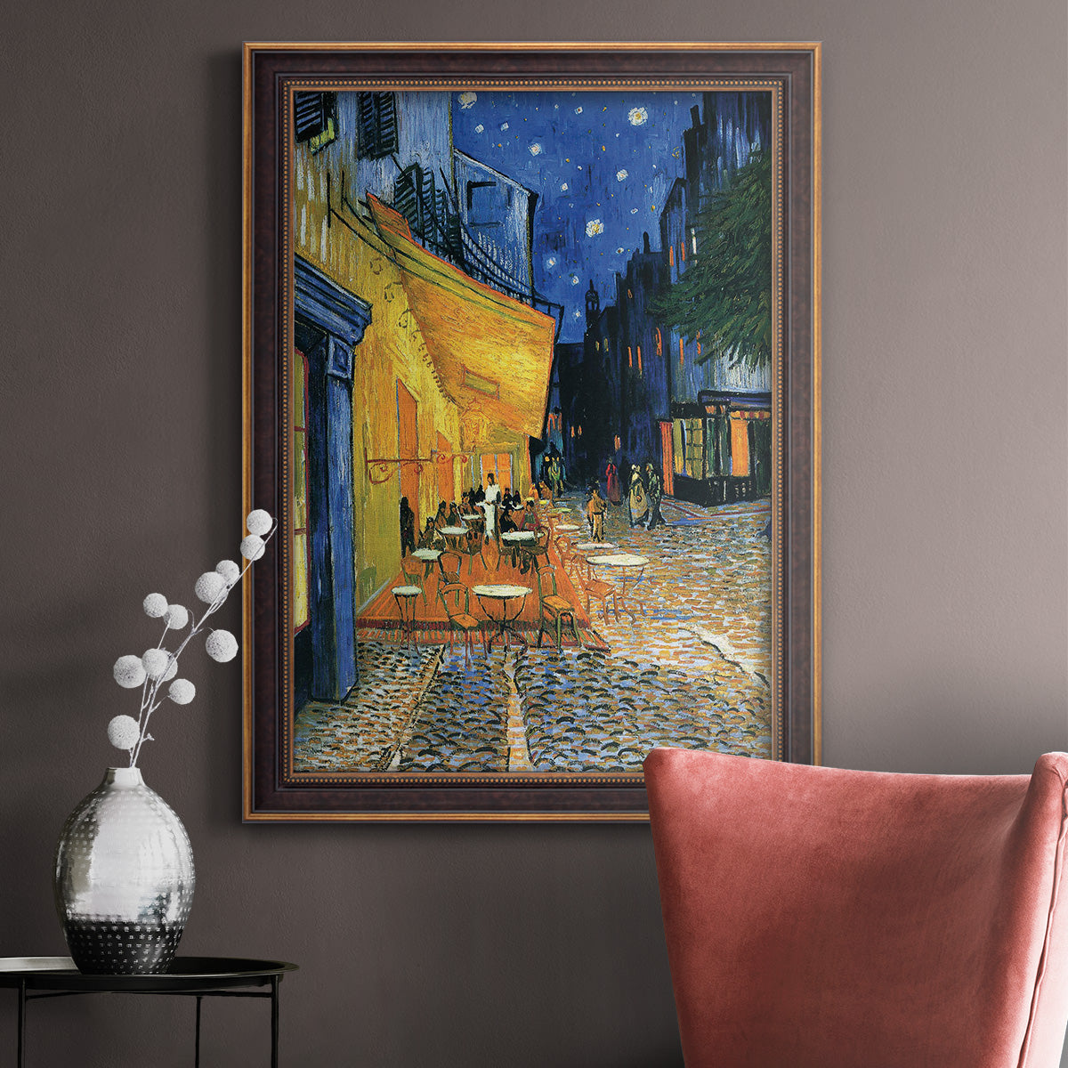 Impressionist night café street scene by Vincent van Gogh in an ornate bronzed mahogany wood frame displayed in a neutral interior setting.