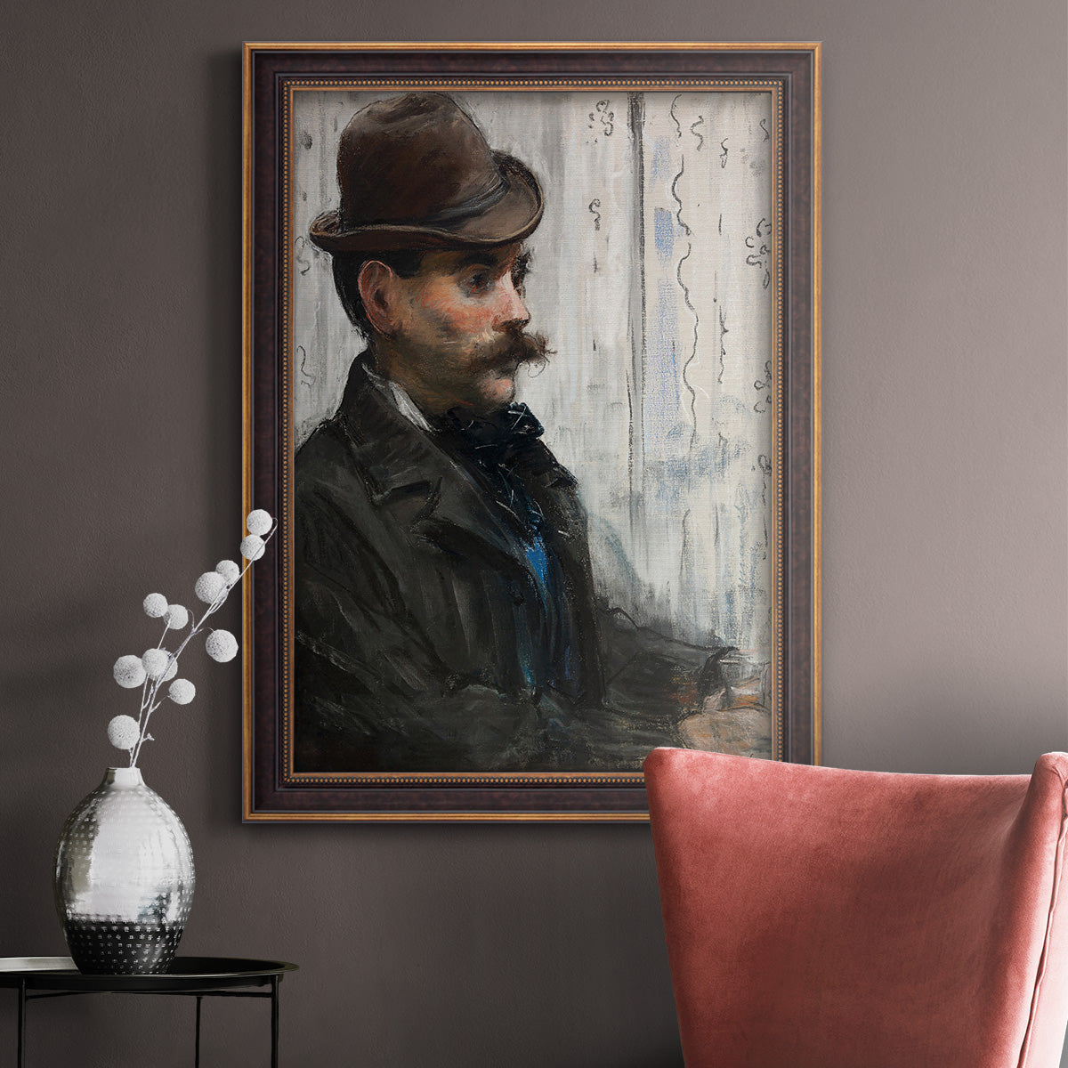 Impressionist portrait of a seated man by Édouard Manet in an ornate bronzed mahogany wood frame displayed in a neutral interior setting.