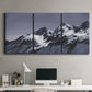 Three-panel canvas wall art featuring moonlit mountain peaks under night sky, displayed above a desk in a home office.
