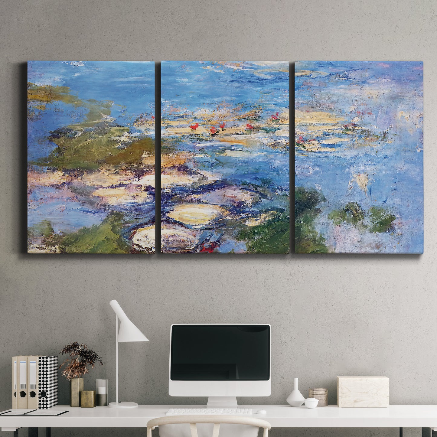Three-panel canvas wall art featuring water lilies in blue and gold, displayed above a desk in a home office.