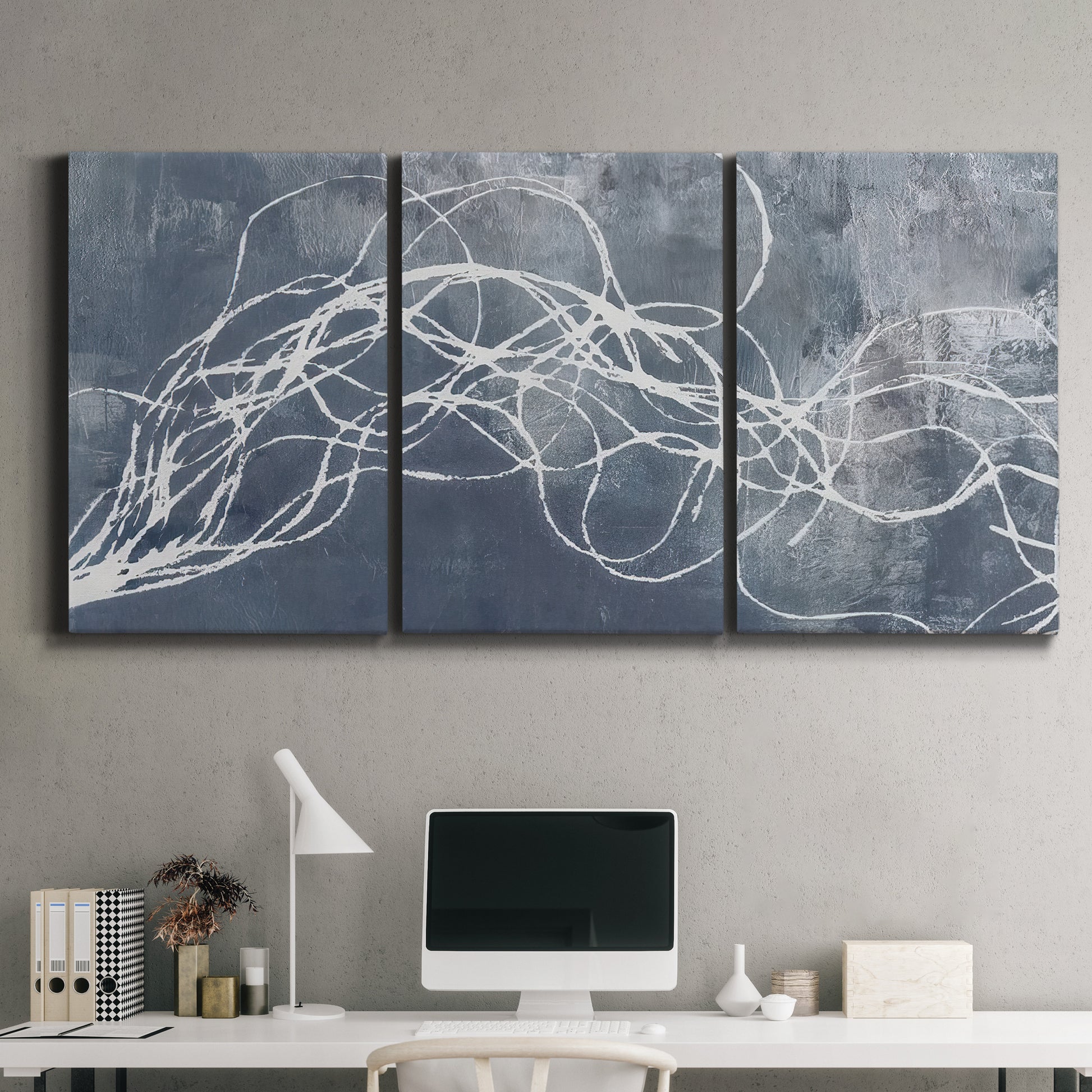 Three-panel canvas wall art featuring coastal shoreline at golden hour, displayed above a desk in a home office.