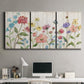Three-panel canvas wall art featuring delicate wildflower illustration, displayed above a desk in a home office.