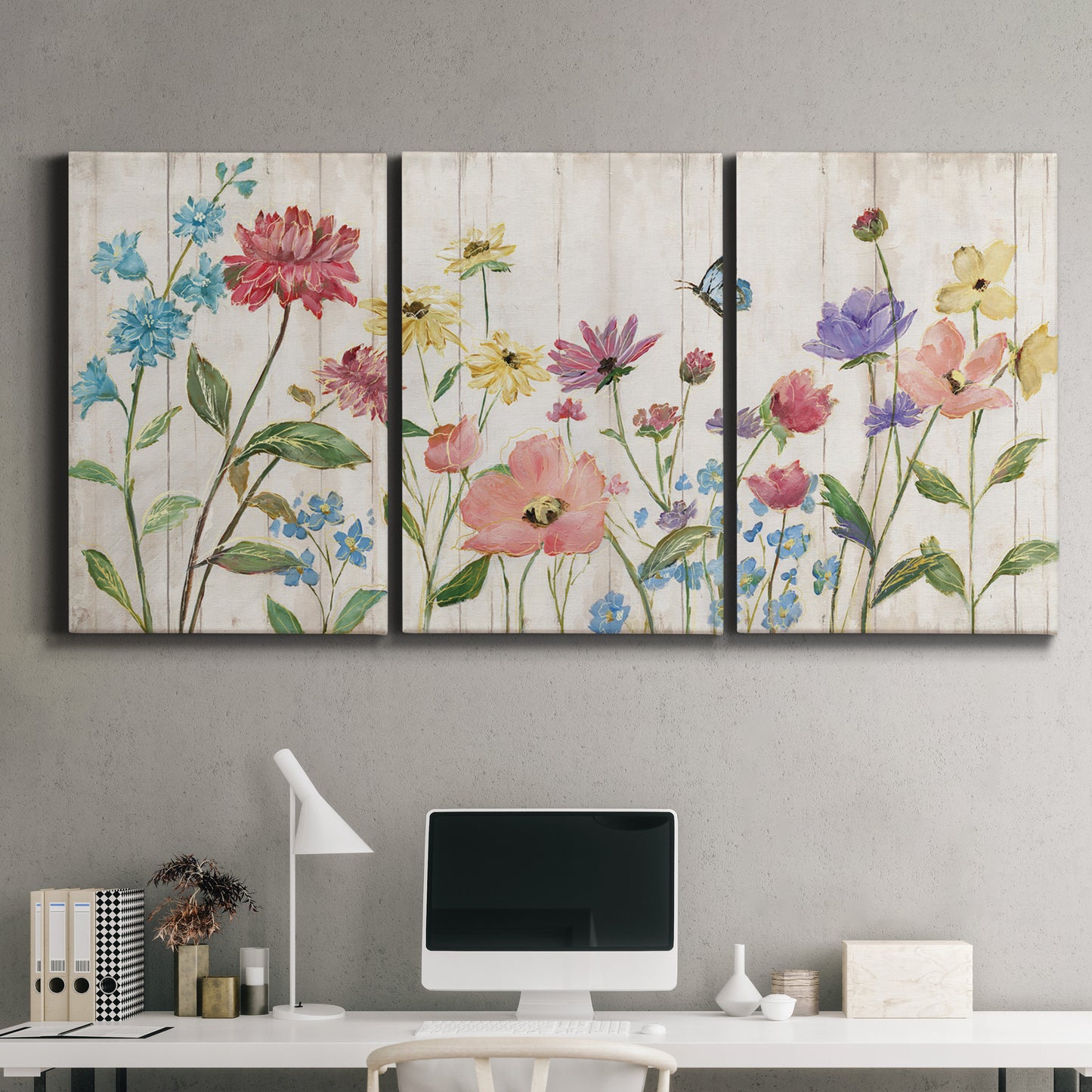 Three-panel canvas wall art featuring delicate wildflower illustration, displayed above a desk in a home office.