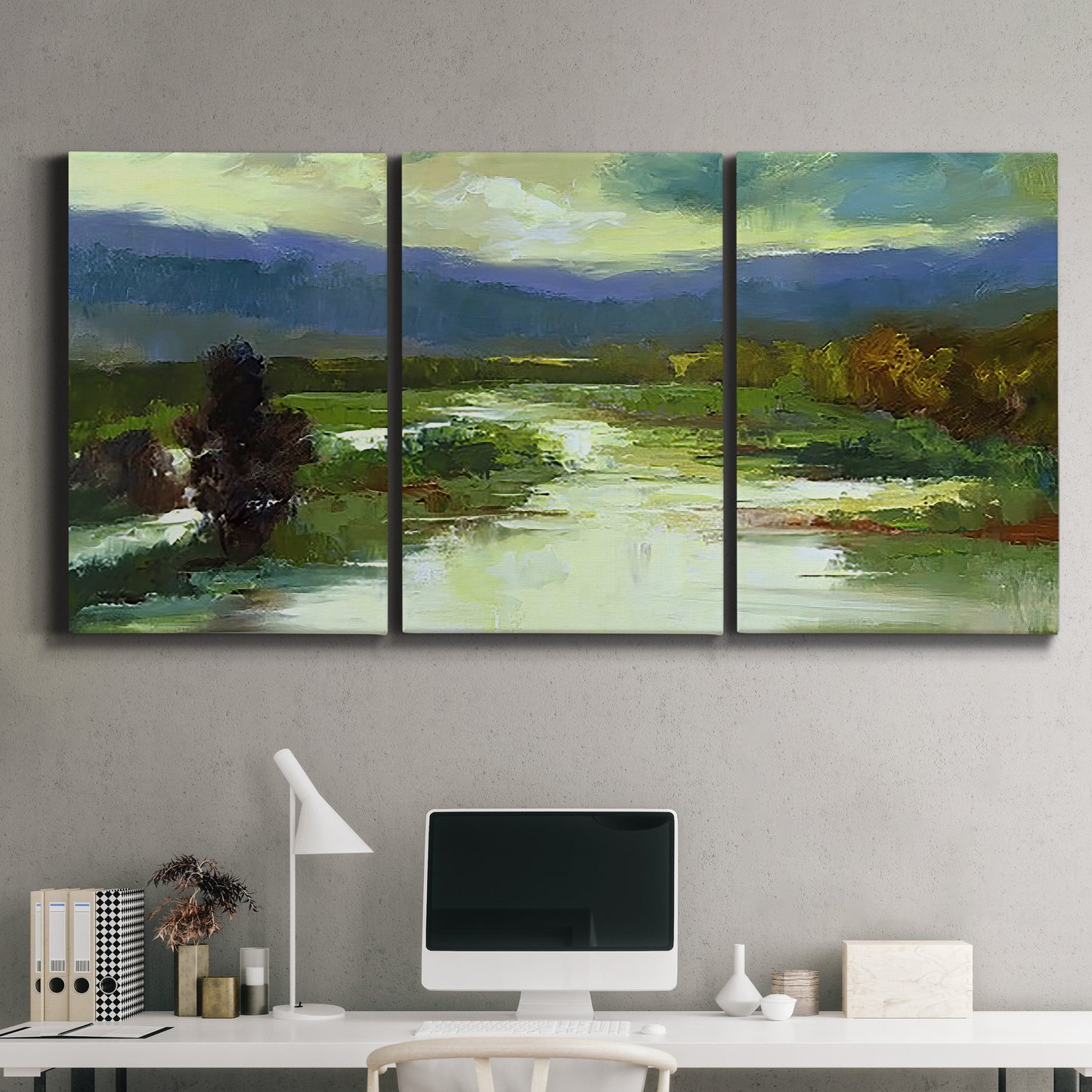 Three-panel canvas wall art featuring open meadow landscape with distant hills, displayed above a desk in a home office.