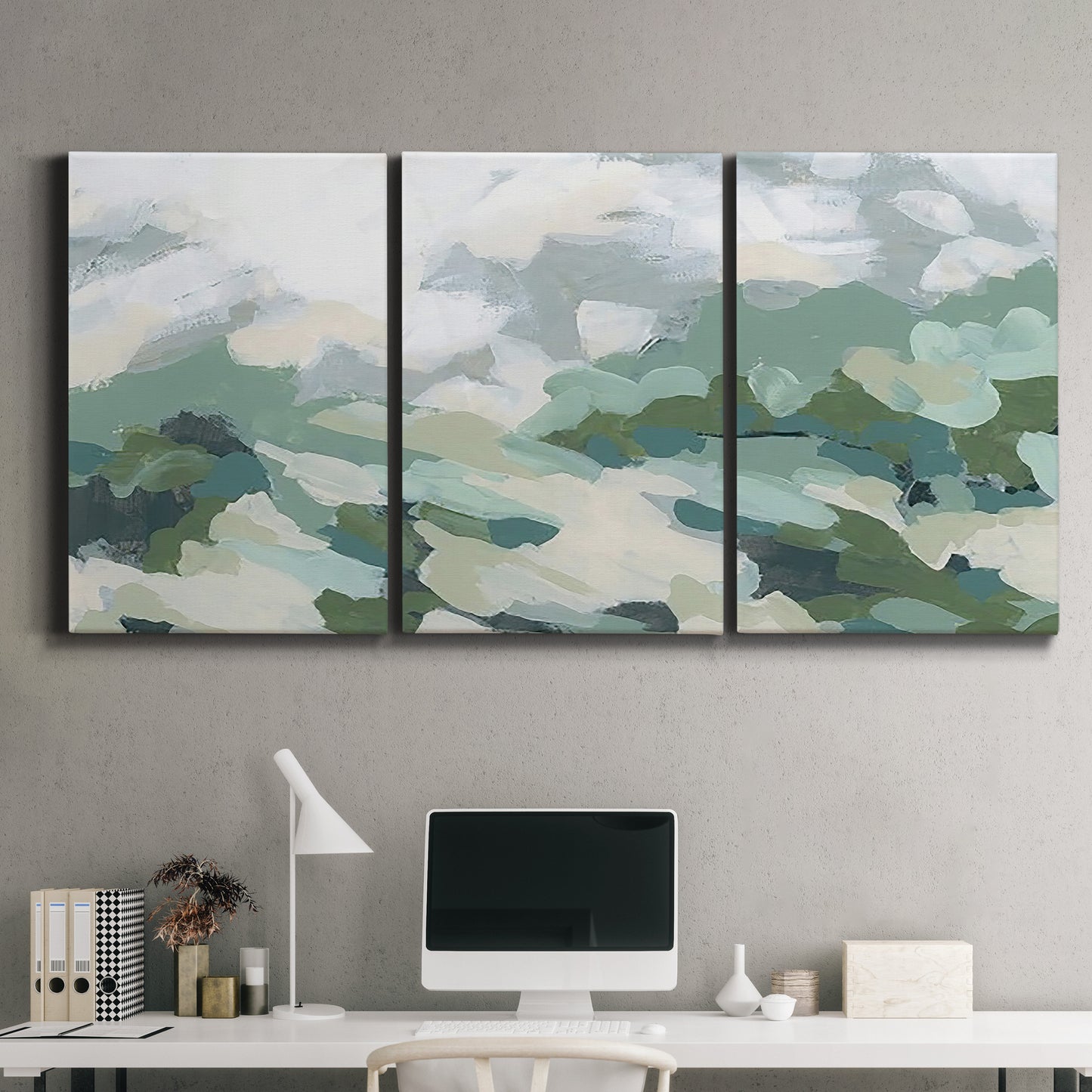 Three-panel canvas wall art featuring lush green hillside rolling landscape, displayed above a desk in a home office.