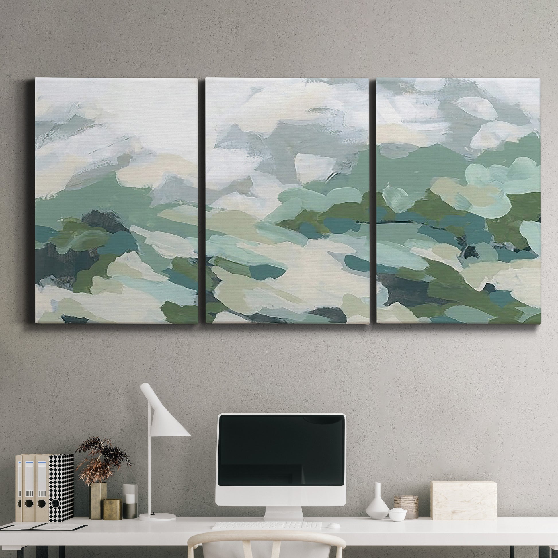Three-panel canvas wall art featuring lush green hillside rolling landscape, displayed above a desk in a home office.