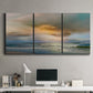 Three-panel canvas wall art featuring tranquil beach at sunset, displayed above a desk in a home office.