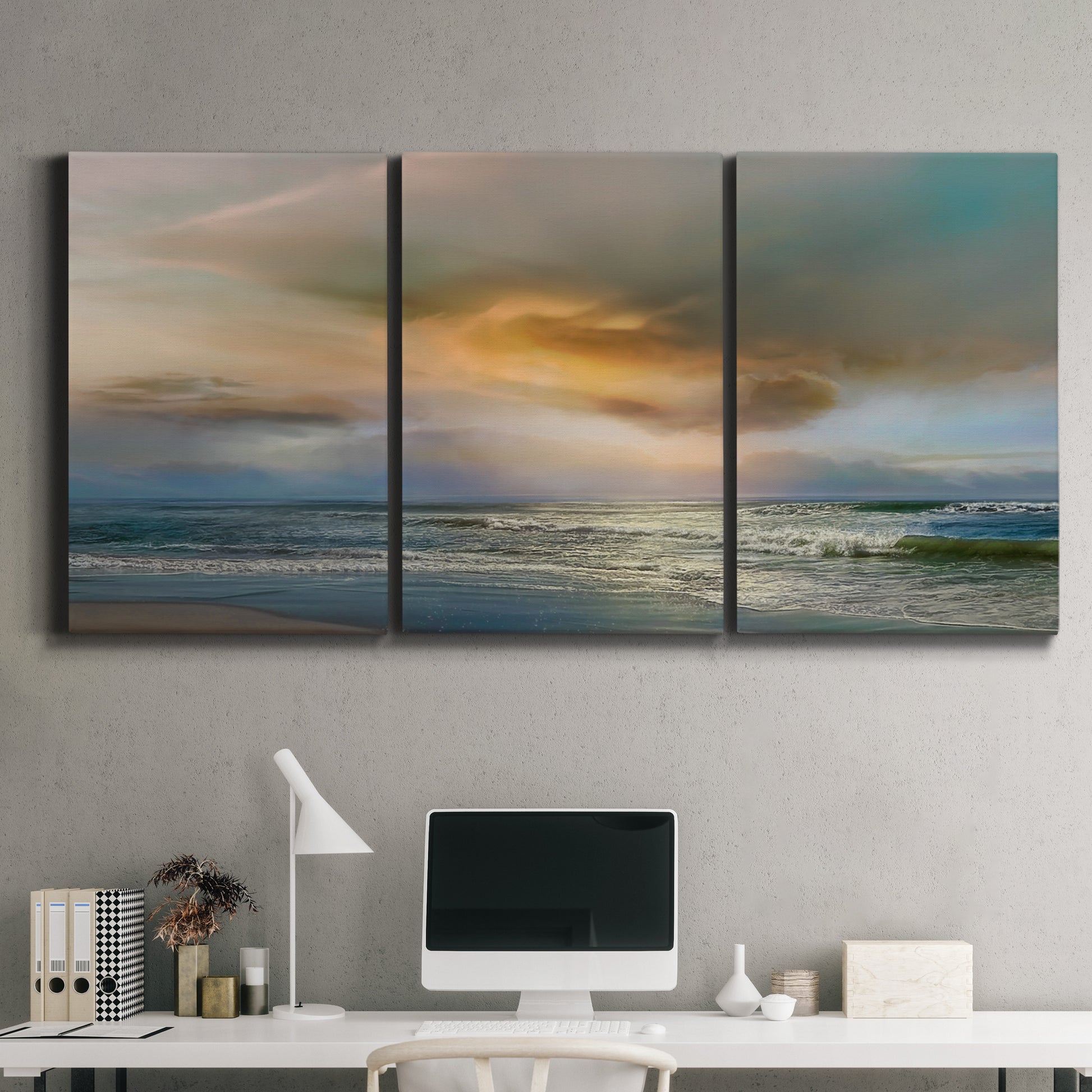 Three-panel canvas wall art featuring tranquil beach at sunset, displayed above a desk in a home office.