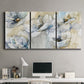 Three-panel canvas wall art featuring delicate watercolor floral blooms, displayed above a desk in a home office.