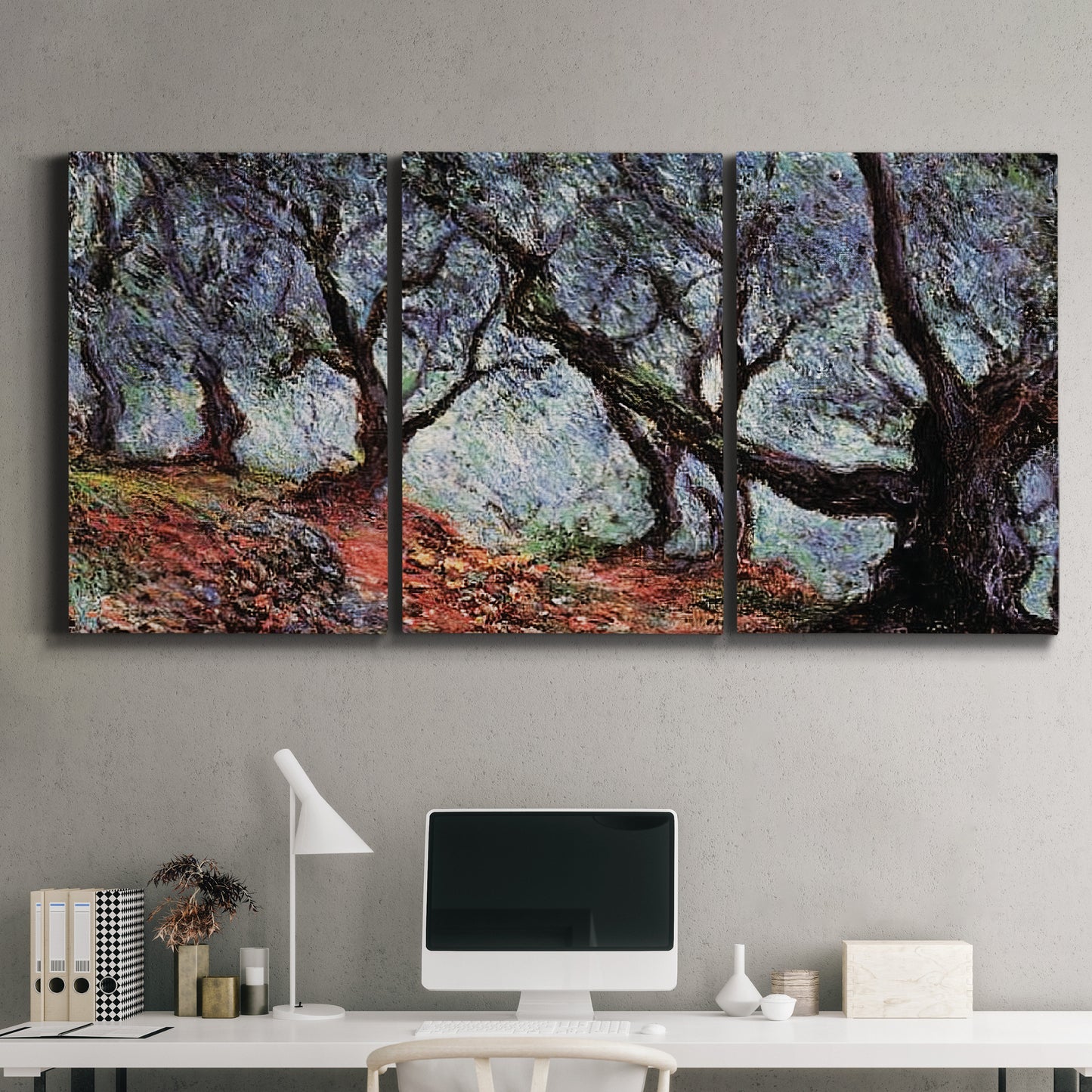 Three-panel canvas wall art featuring pine trees silhouetted at evening, displayed above a desk in a home office.
