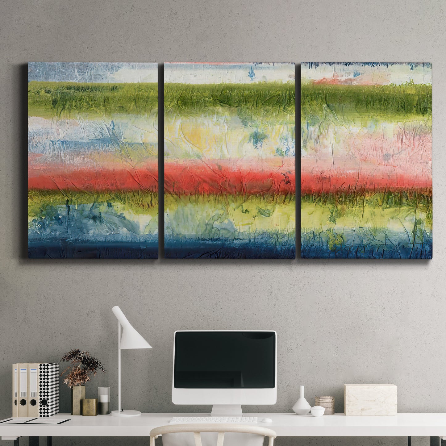 Three-panel canvas wall art featuring layered abstract color banding, displayed above a desk in a home office.