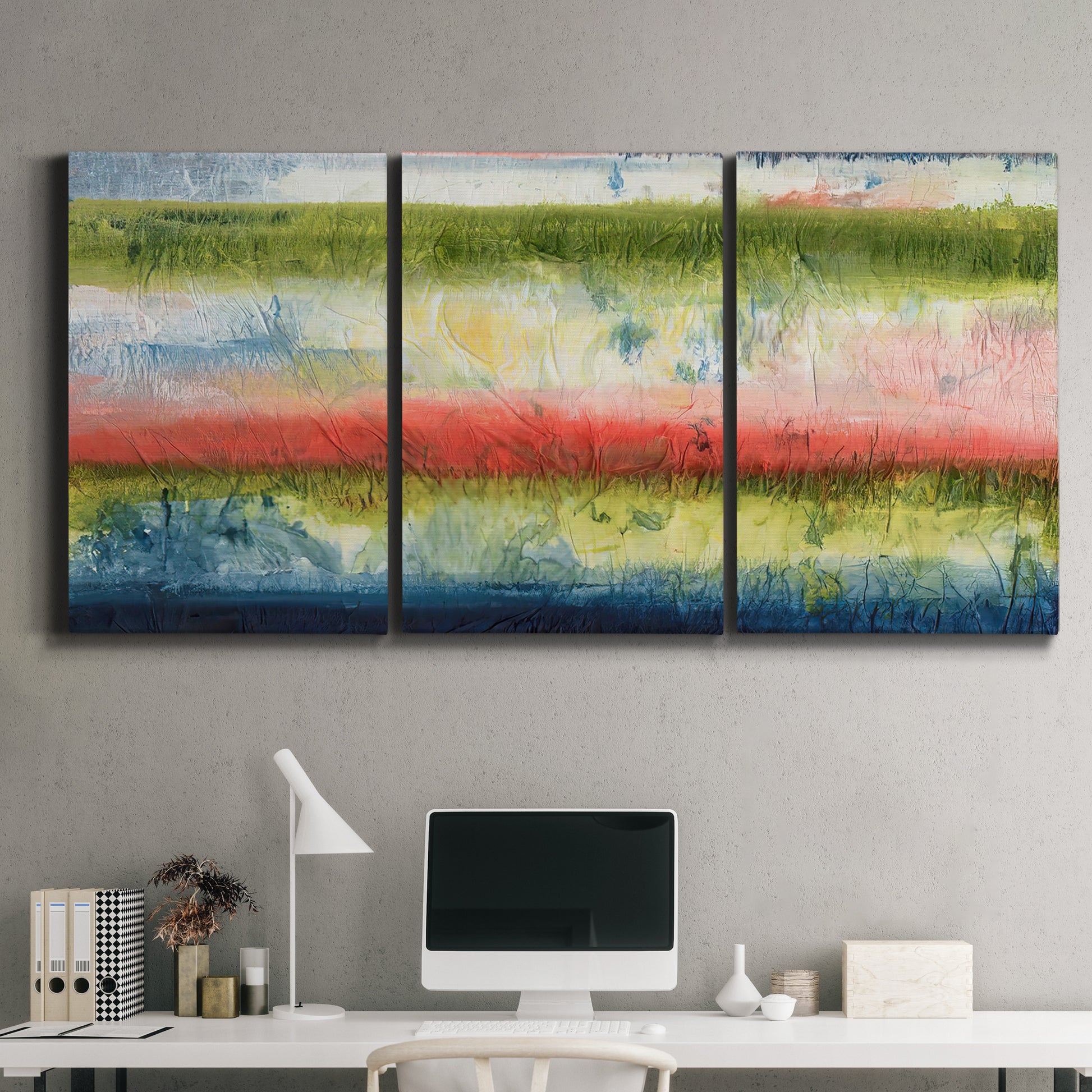 Three-panel canvas wall art featuring layered abstract color banding, displayed above a desk in a home office.