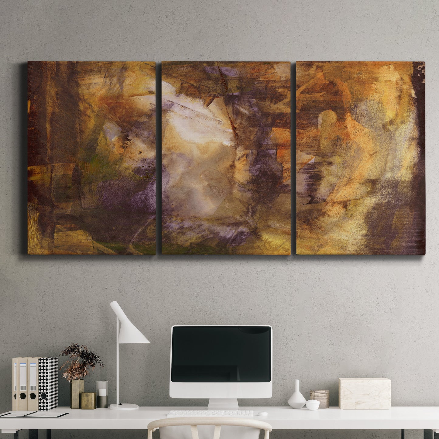 Three-panel canvas wall art featuring abstract architectural landscape, displayed above a desk in a home office.