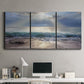 Three-panel canvas wall art featuring soft sunrise over open water, displayed above a desk in a home office.