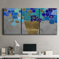 Three-panel canvas wall art featuring blue floral abstract botanical expression, displayed above a desk in a home office.