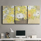 Three-panel canvas wall art featuring abstract floral table arrangement, displayed above a desk in a home office.