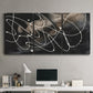 Three-panel canvas wall art featuring dark swirling abstract motion, displayed above a desk in a home office.